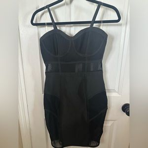 Bodycon black dress with sheer paneling. Size: S